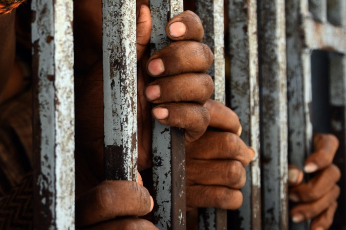 prison-black-hands-on-bars
