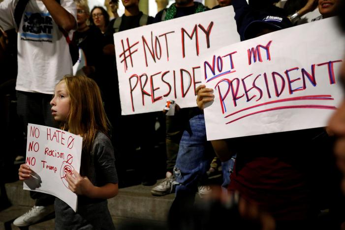 A girl joins demonstrators to protest outside of City Hall following the election of Republican Donald Trump as President of the United States in downtown Los Angeles, California November 10, 2016. REUTERS/Patrick T. Fallon